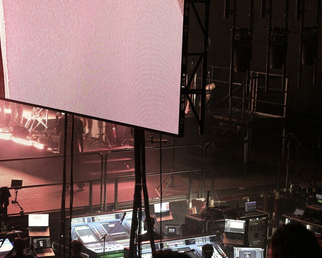 People working at a control desk with screens.