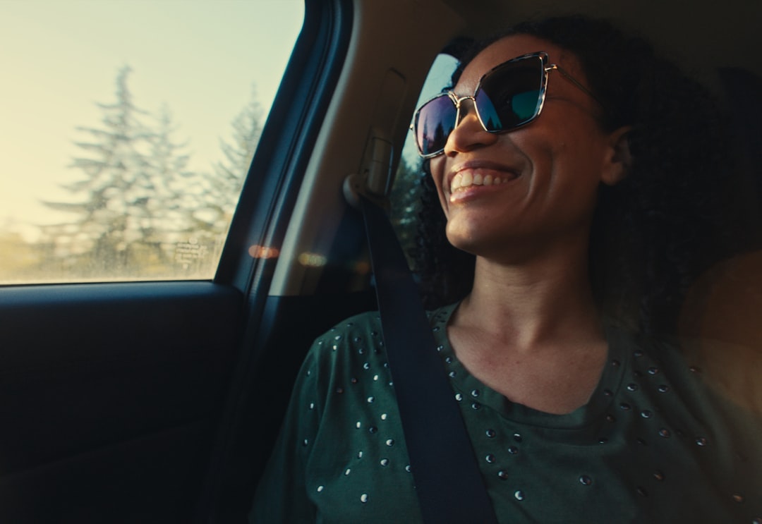 Happy woman smiling and enjoying a car ride.